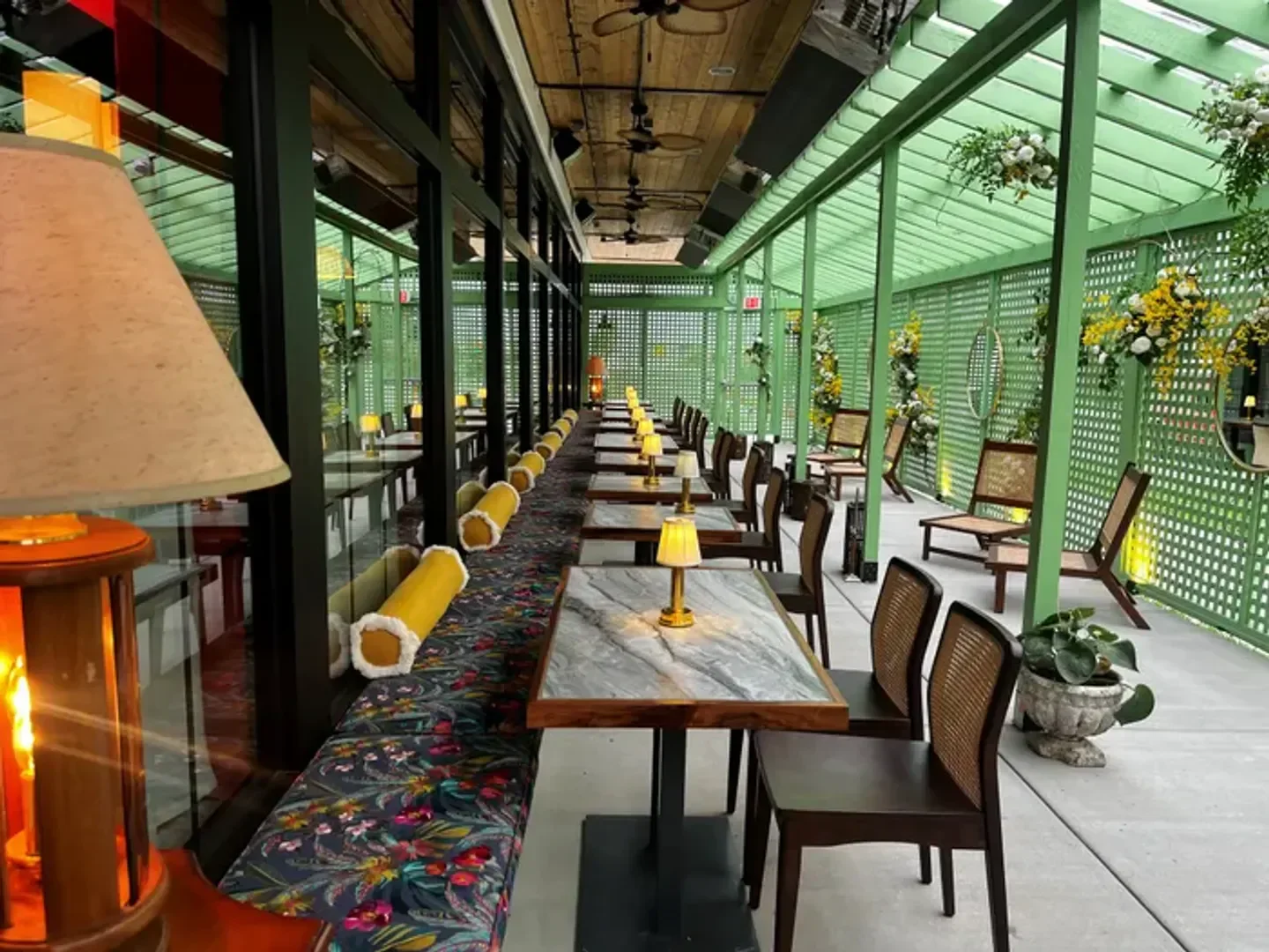 Elegant dining space at Fancypants restaurant in Nashville, with floral decor and outdoor seating.