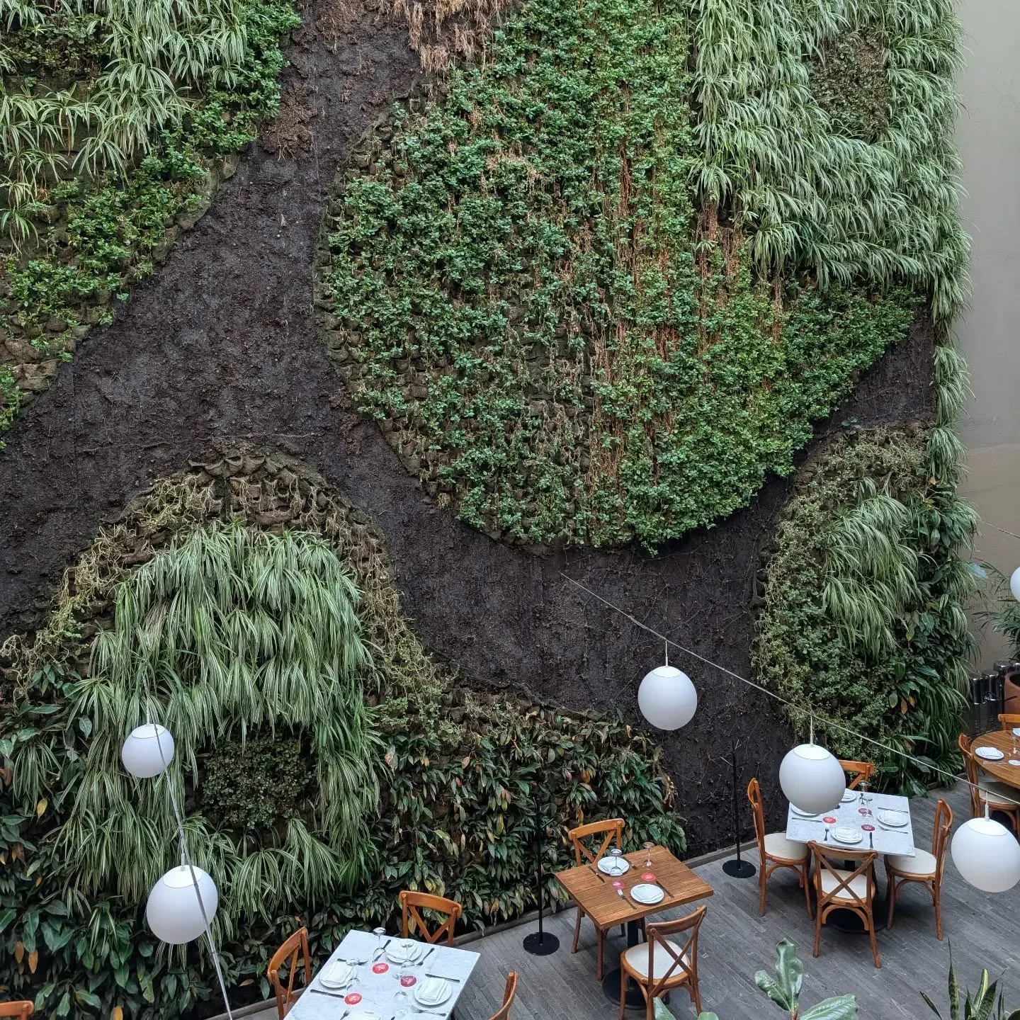 Fang Xiang Jing restaurant in Chengdu with a stunning vertical garden and dining area.