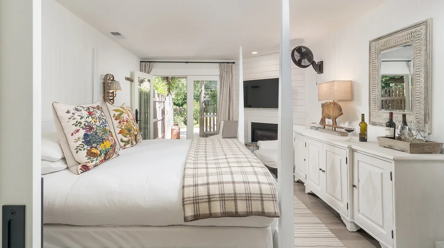 Cozy bedroom at Farmhouse Inn in Sonoma, with fireplace and inviting decor.