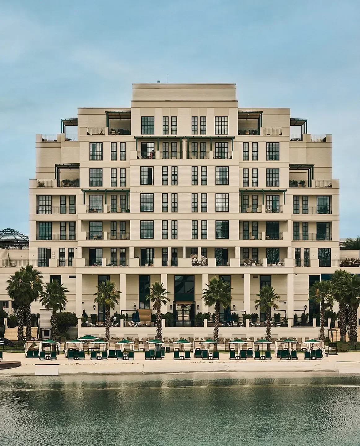 Exterior of Fasano Sao Paulo restaurant with a beach front and palm trees