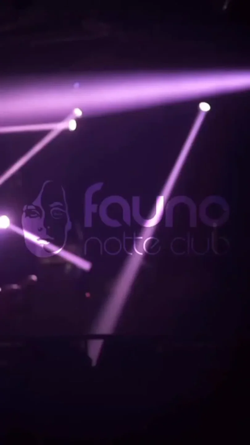 Dynamic purple laser lights illuminate the Fauno Notte Club, setting a vibrant mood for the city's nightlife.