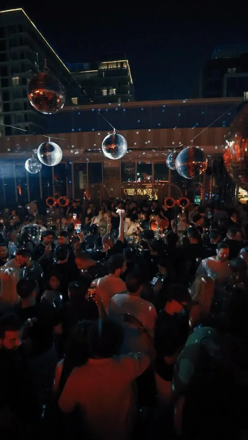 Lively atmosphere at February 30 restaurant in the city with disco balls and dancing crowd.