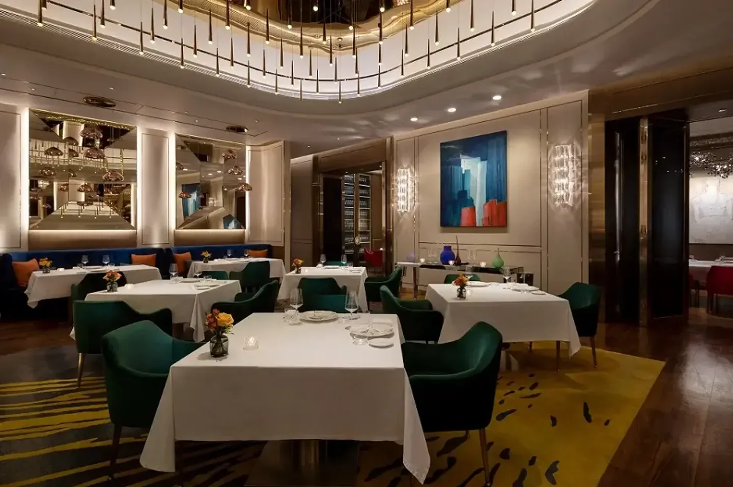 Elegant interior of Feng Wei Ju restaurant in Macau with tables set for dining.