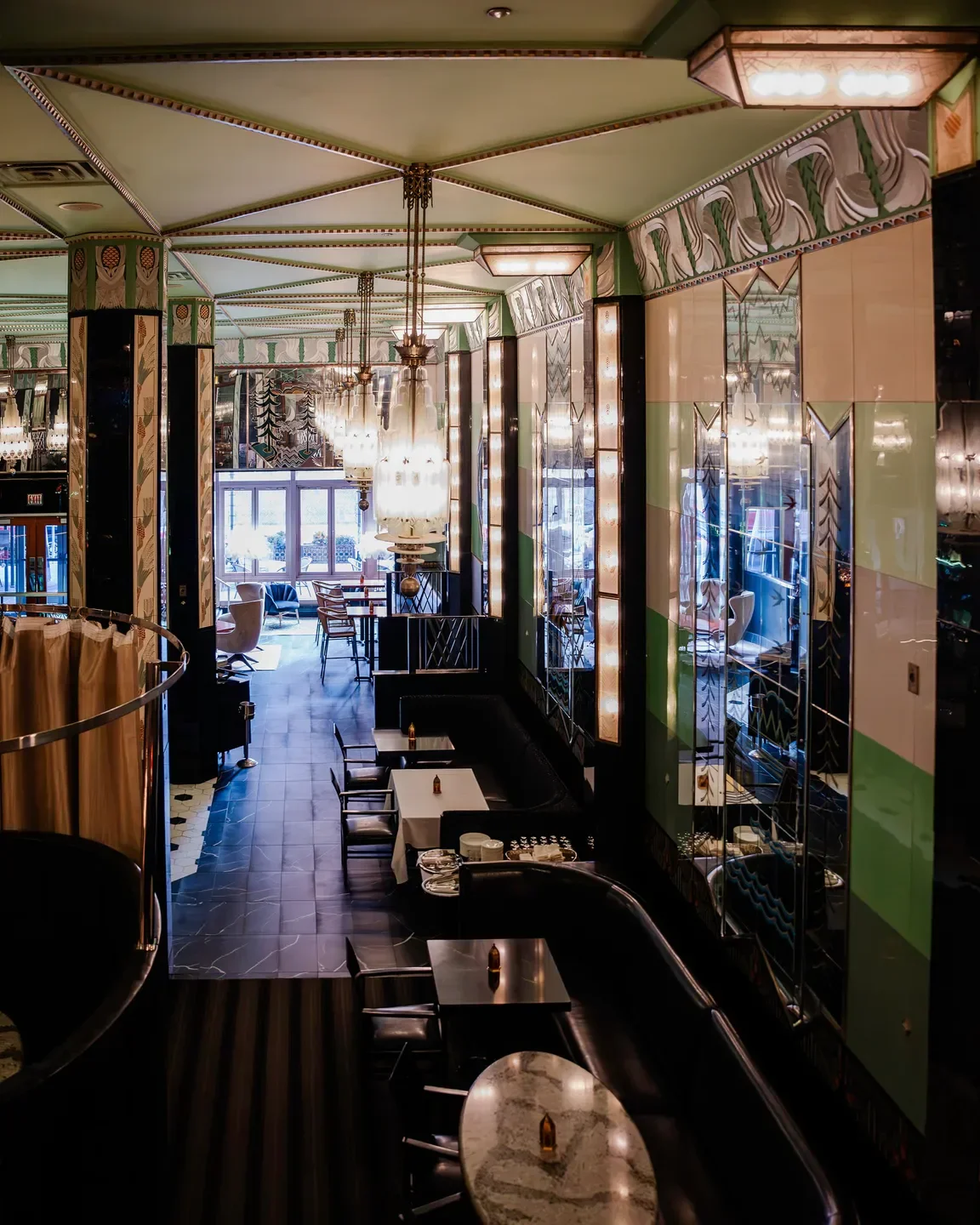Art Deco interior of Fhima's restaurant in Minneapolis with elegant chandeliers and tables.