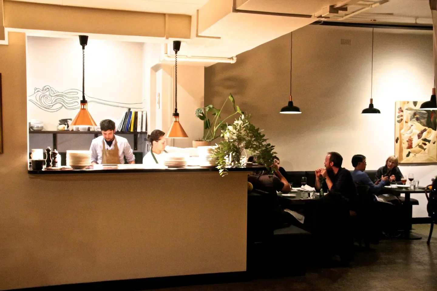 Interior view of Fico restaurant in Hobart, with chefs and diners enjoying the ambiance.