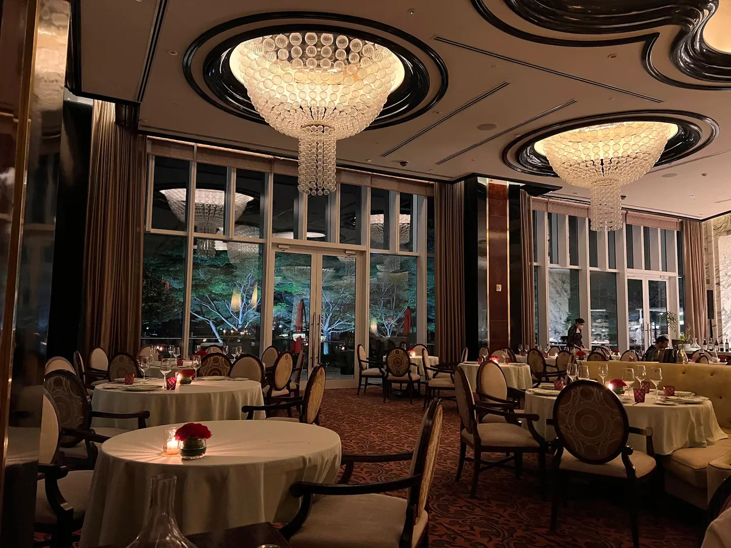 Elegant interior of Finestra Italian Steakhouse in Manila, featuring chandeliers and tables.