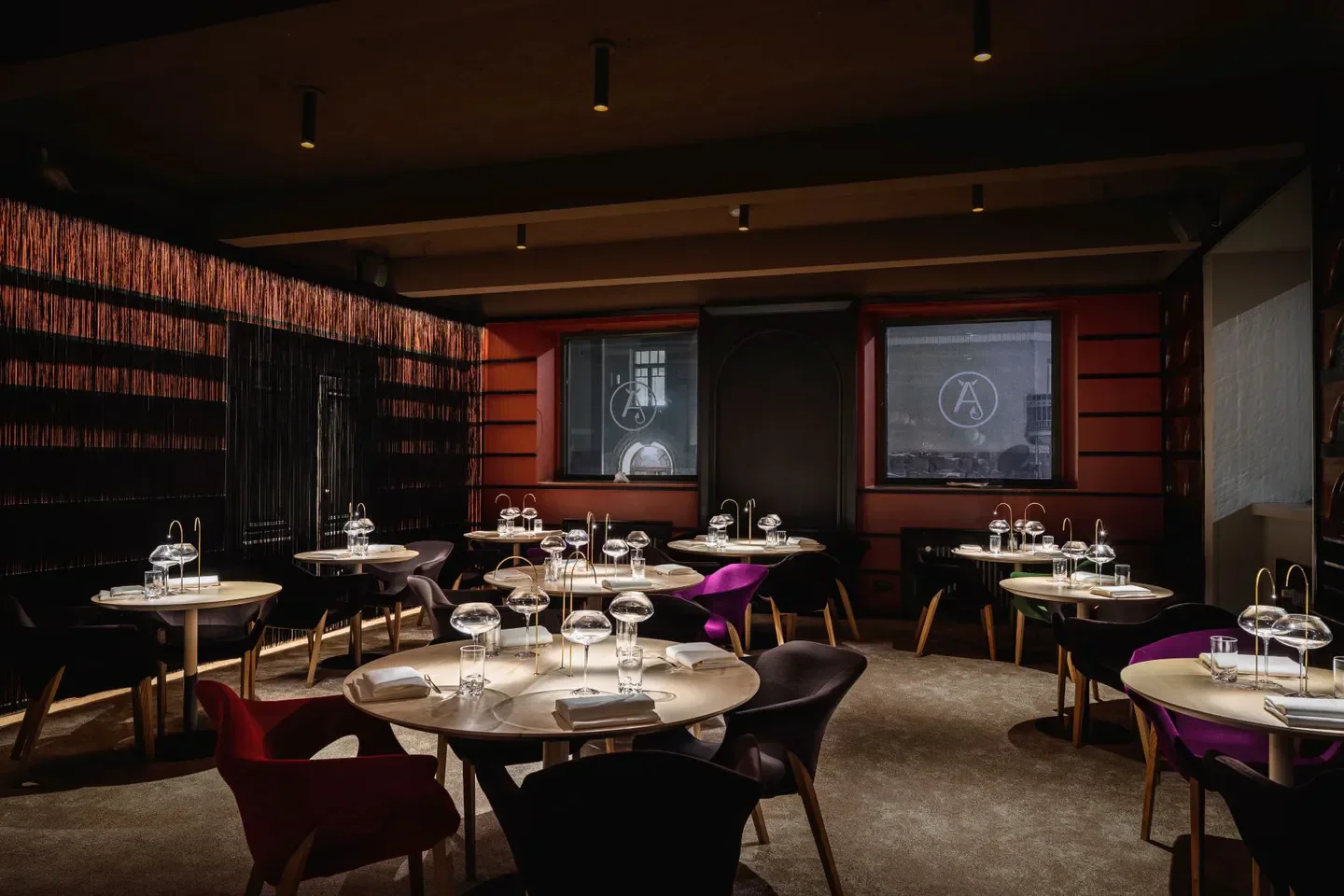 Interior dining at Finnjävel Salonki restaurant in Helsinki, featuring elegant tables and decor.
