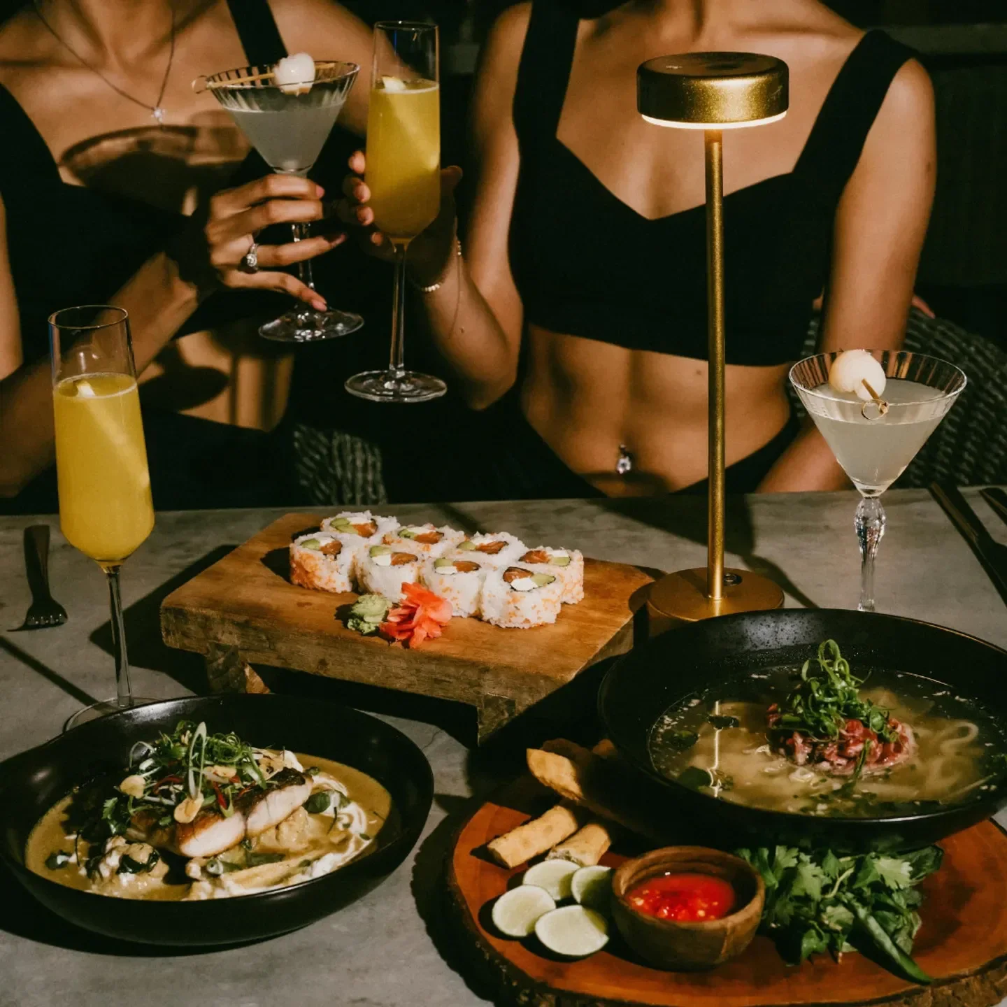 Delicious sushi and cocktails at Finns Beach Club restaurant in Bali with friends.