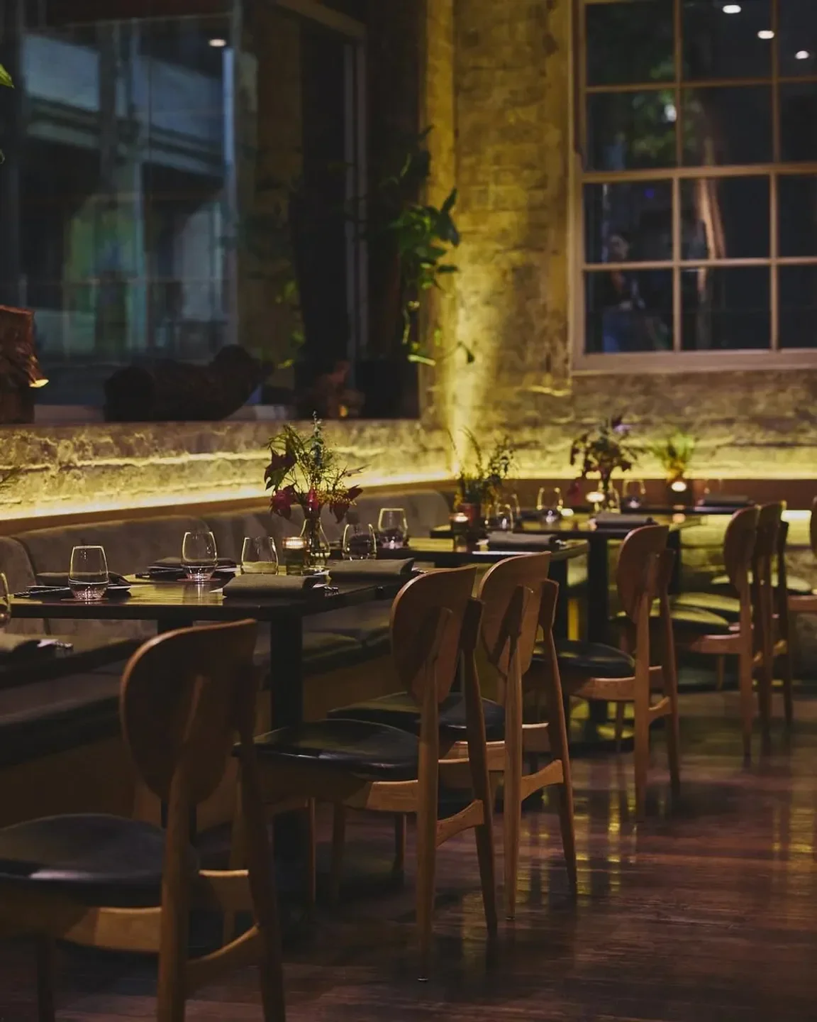 Cozy dining area at FIREDOOR restaurant in Sydney, featuring wooden chairs and tables.
