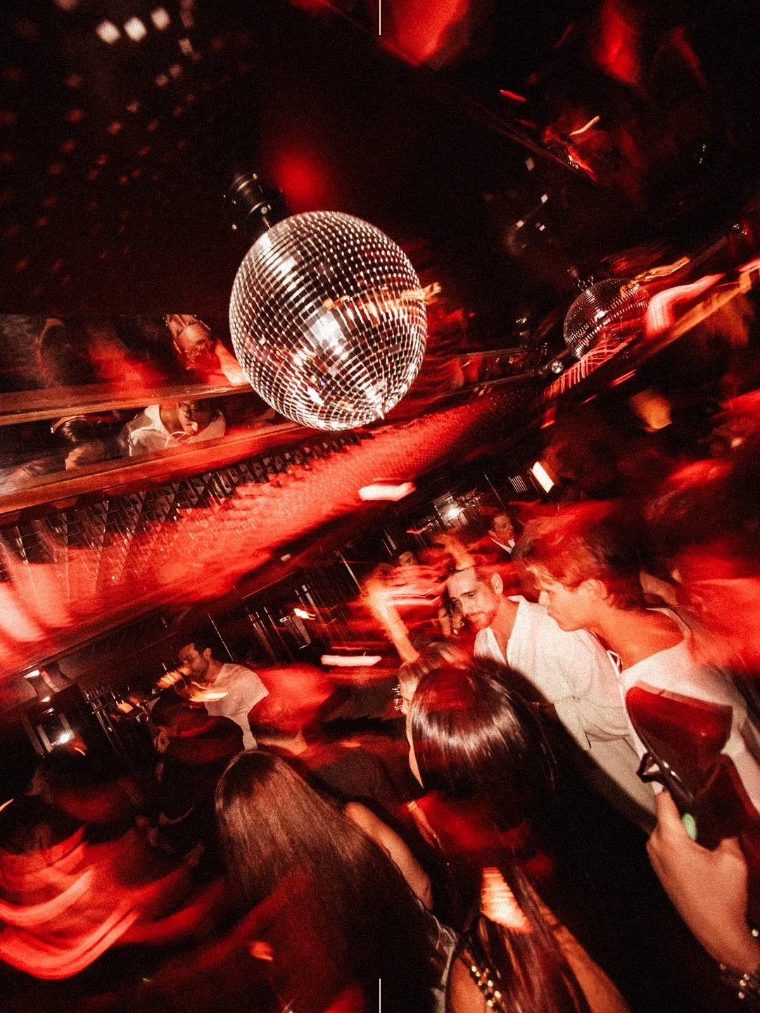 Energetic disco ball ambiance at FLASH Cannes nightclub, illuminating the crowd in the city.