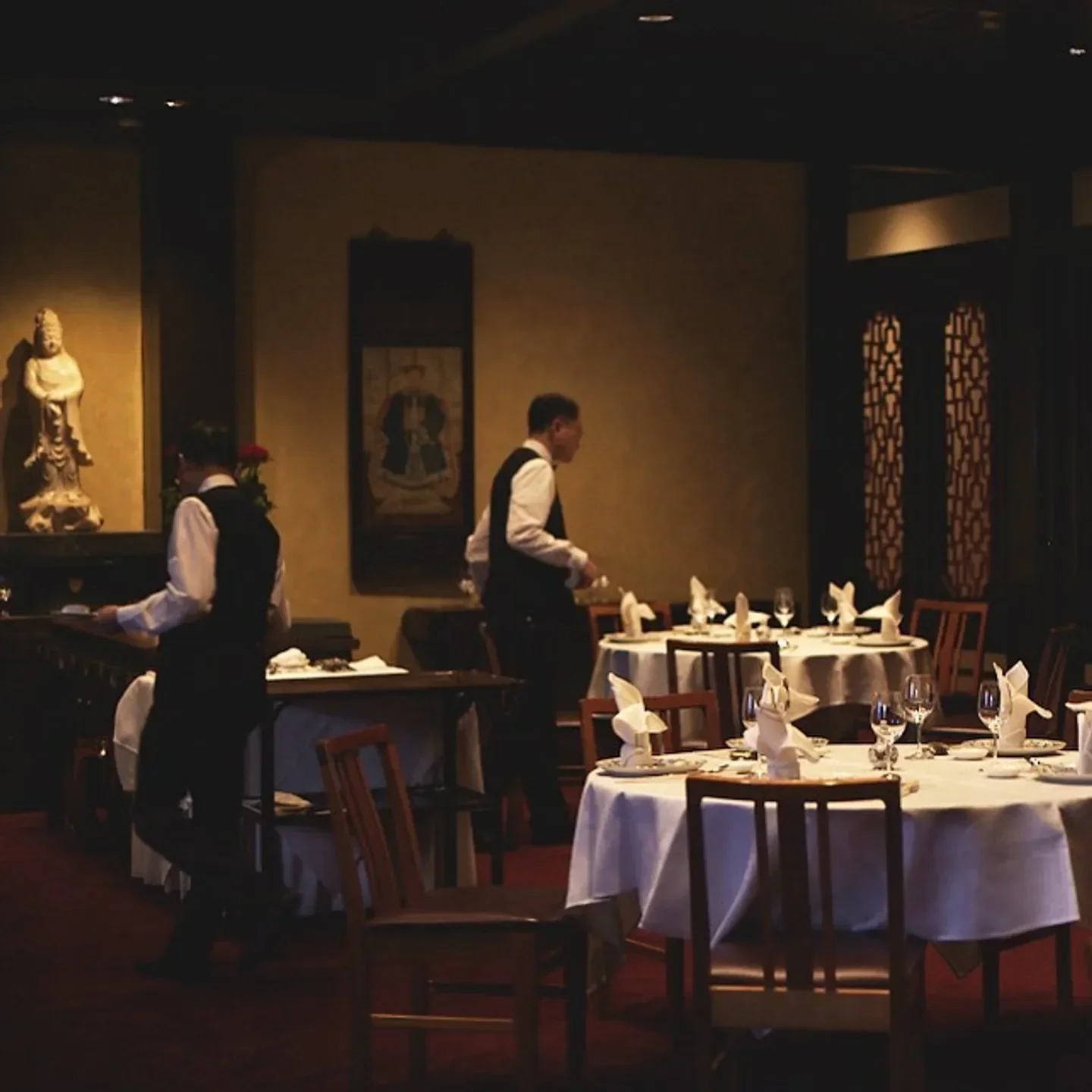 Interior of Flower Drum in Melbourne, featuring elegant tables and waitstaff service.