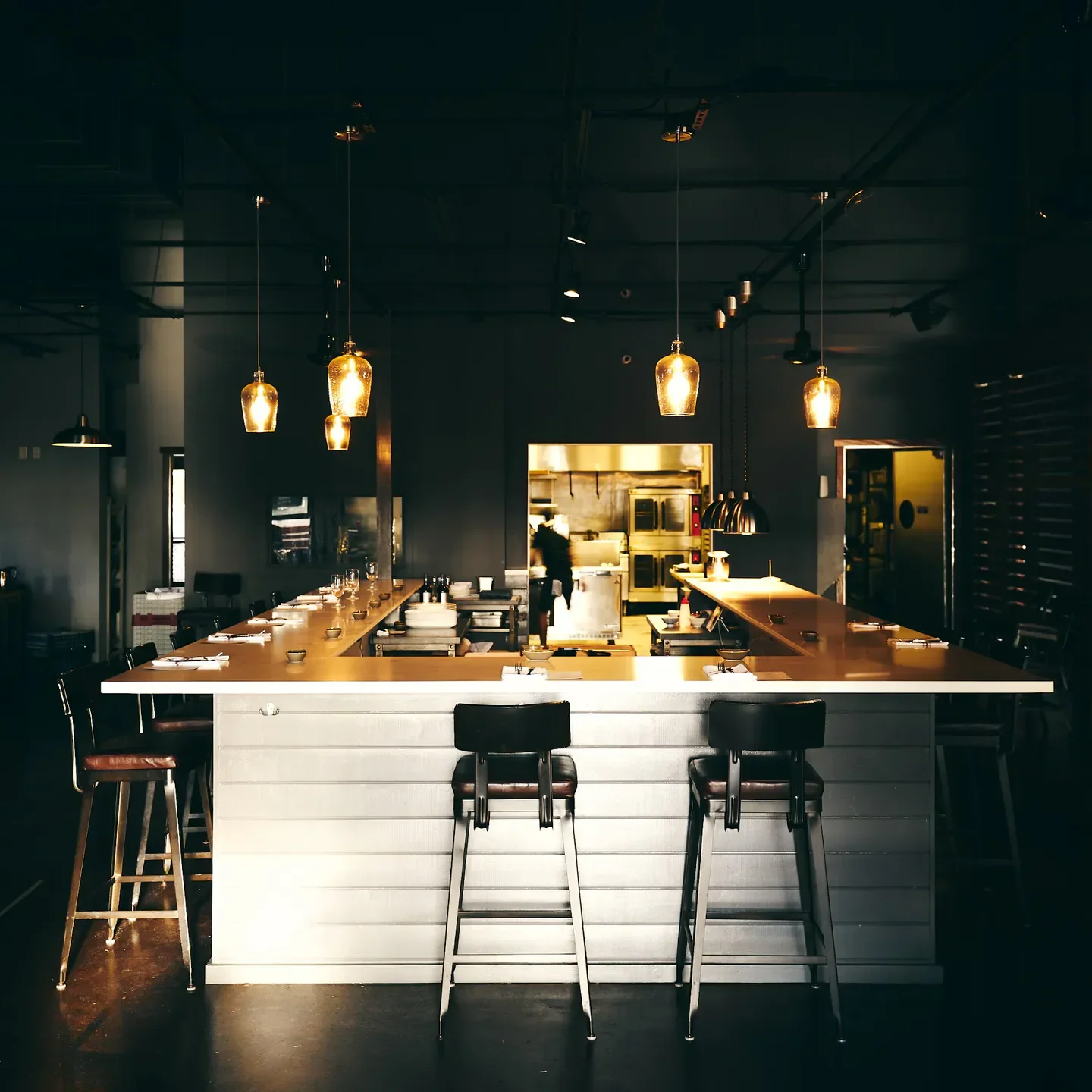Interior of Fond restaurant in Maui, showcasing bar seating and elegant lighting.