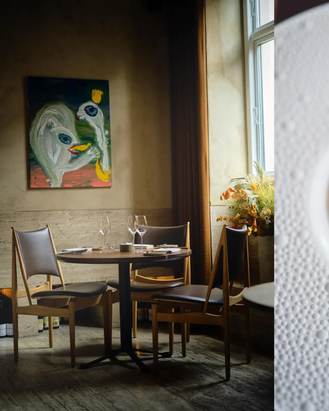 Cozy dining area at formel B restaurant in Copenhagen, featuring a round table and artistic decor.