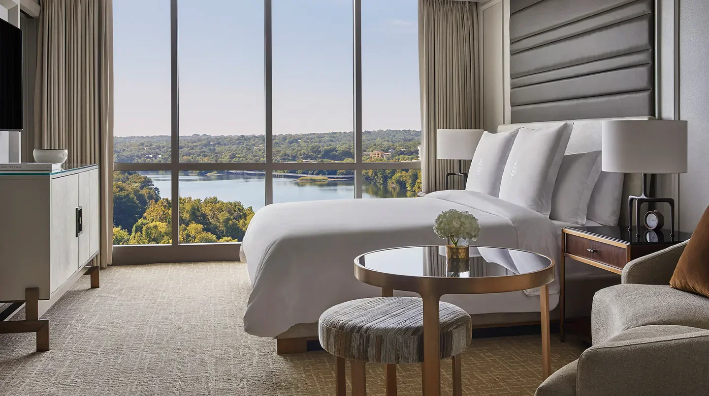 Elegant Four Seasons Hotel Austin bedroom overlooking the beautiful Austin landscape and lake.