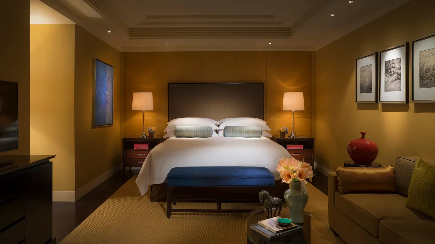 Cozy bedroom at the Four Seasons Hotel Beijing. Luxurious bedding and elegant design in Beijing.
