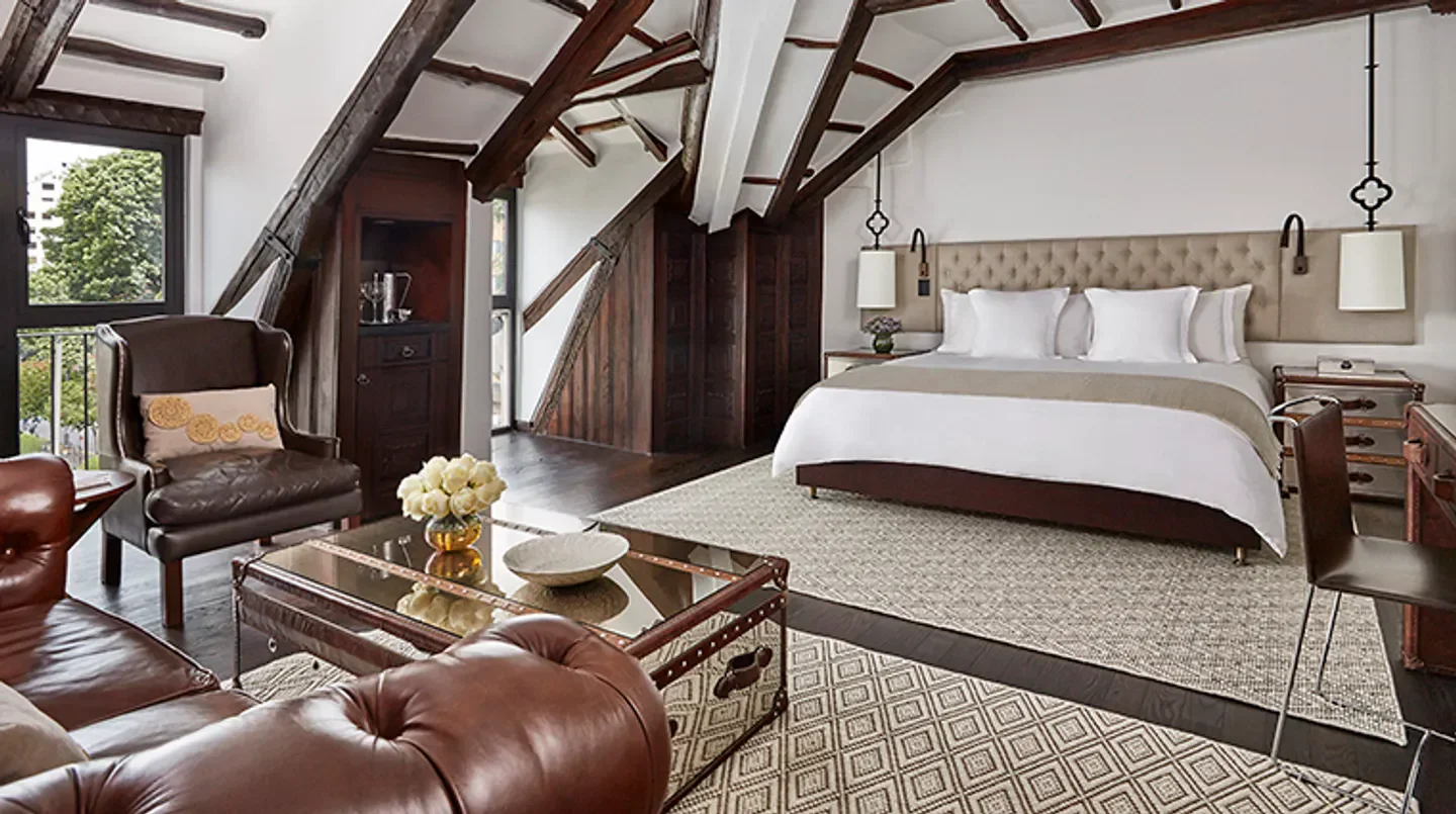 Cozy bedroom at the Four Seasons Hotel Casa Medina Bogota, featuring wooden beams.