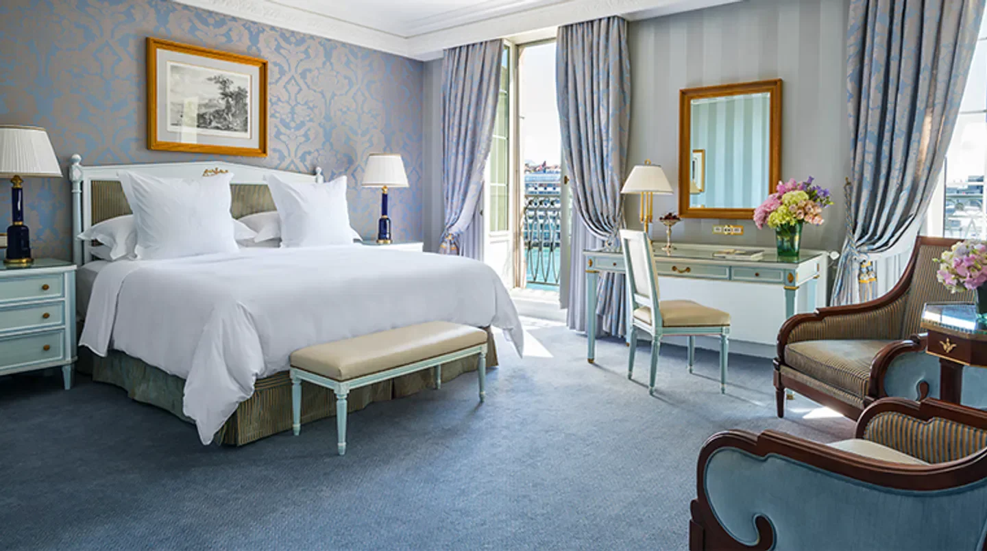 Elegant bedroom at Four Seasons Hotel des Bergues Geneva, with views in Geneva.