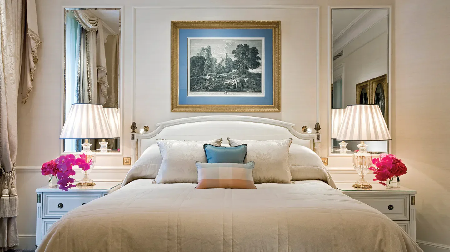 Elegant bedroom at Four Seasons Hotel George V, Paris, featuring artwork and cozy ambiance in Paris