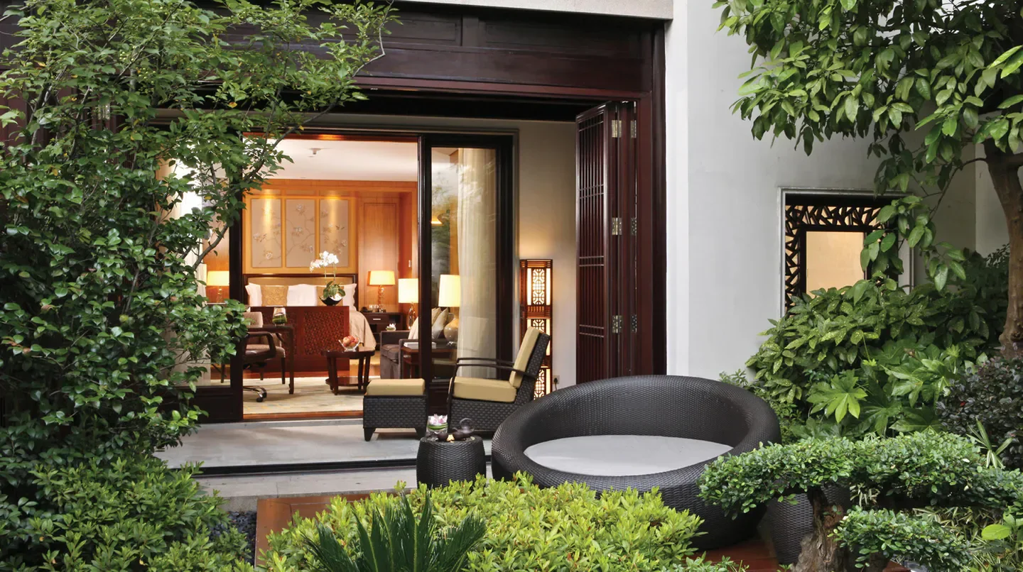 Outdoor patio at Four Seasons Hotel Hangzhou at West Lake, Hangzhou, with garden views.