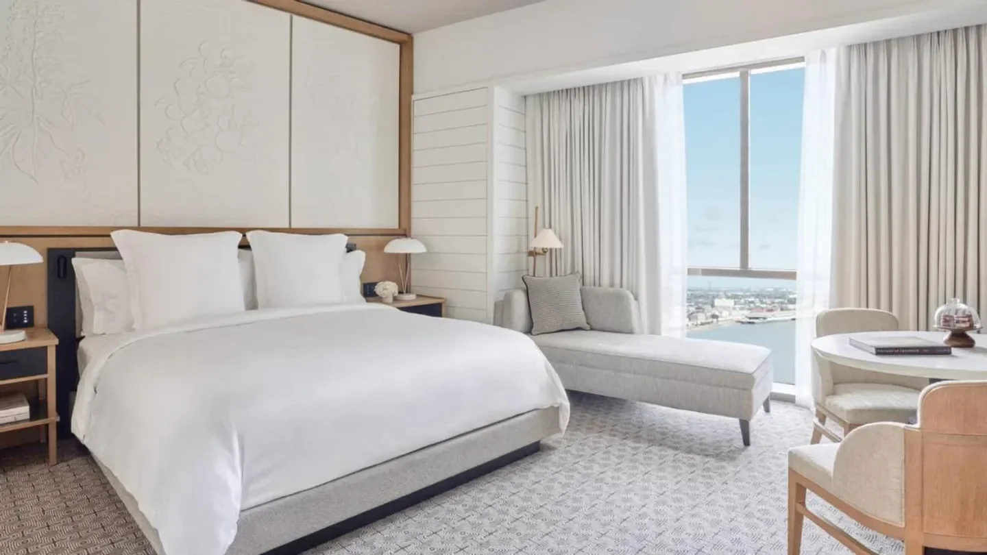Elegant bedroom at the Four Seasons Hotel New Orleans, overlooking the city.