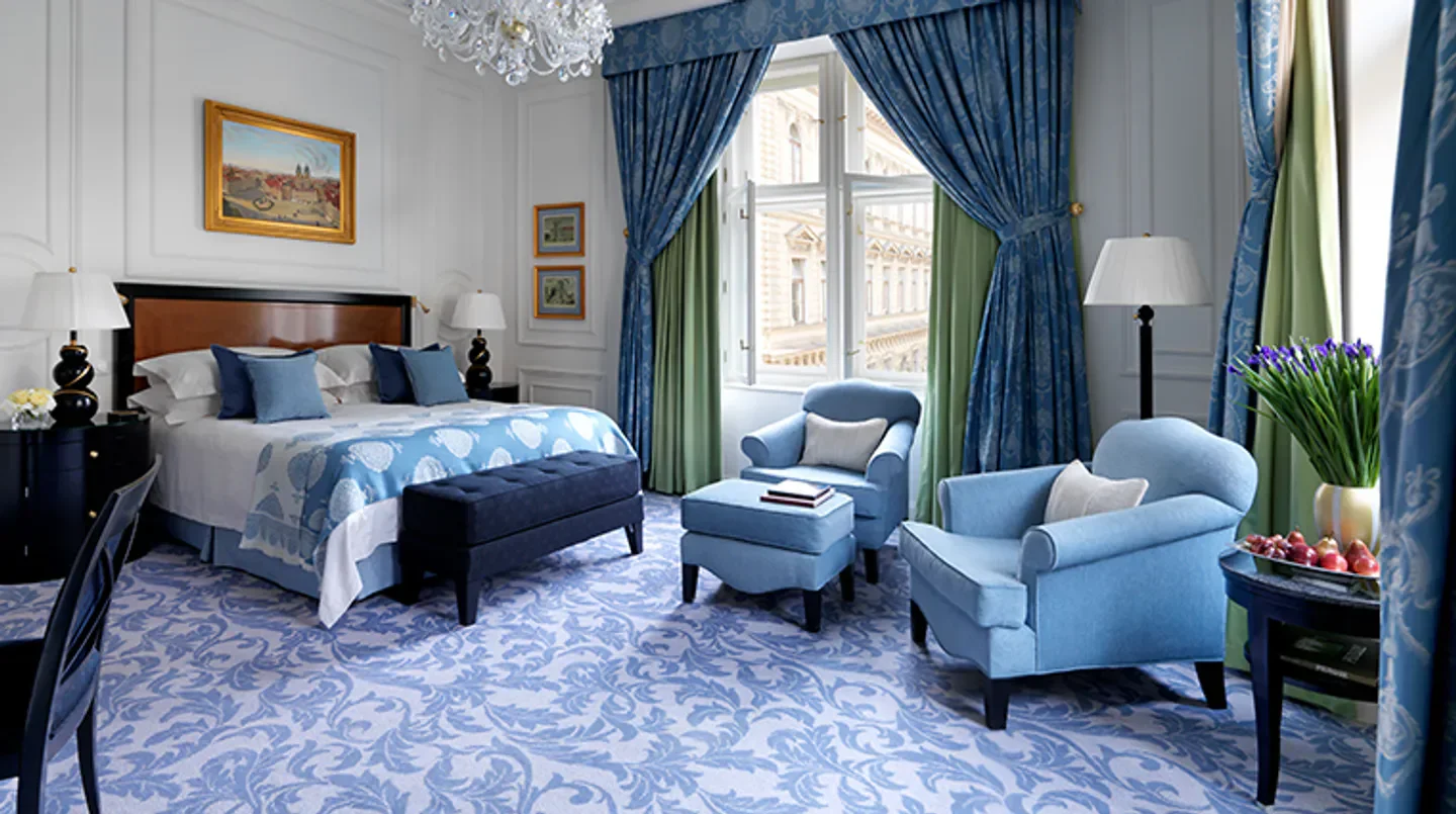 Elegant bedroom at the Four Seasons Hotel Prague, with views over Prague.