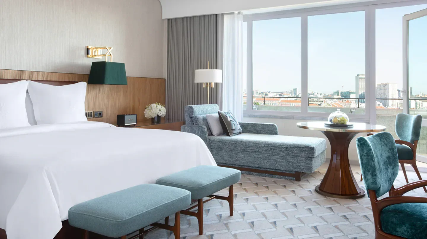 Elegant bedroom at Four Seasons Hotel Ritz Lisbon, overlooking the beautiful city of Lisbon.