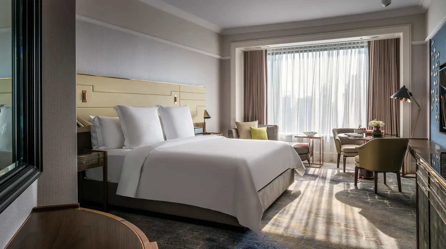 Elegant bedroom at Four Seasons Hotel Singapore, showcasing luxury in Singapore.