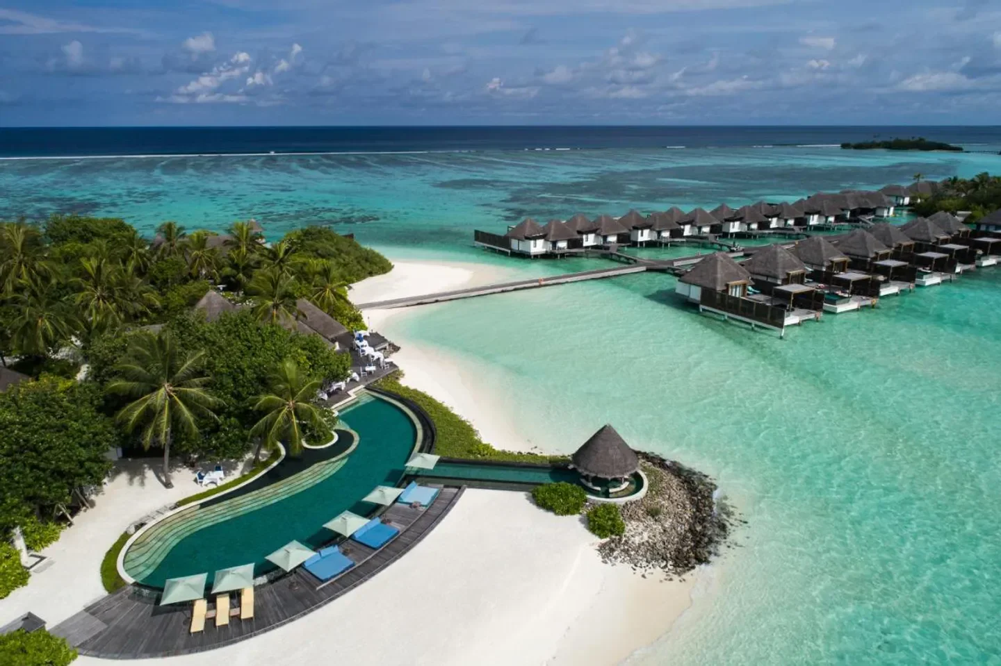 Aerial view of Four Seasons Resort Maldives at Kuda Huraa with turquoise water and villas