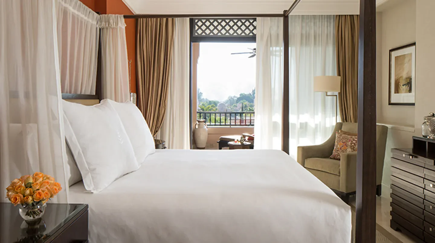 Four Seasons Resort Marrakech bedroom with a balcony overlooking Marrakech scenery