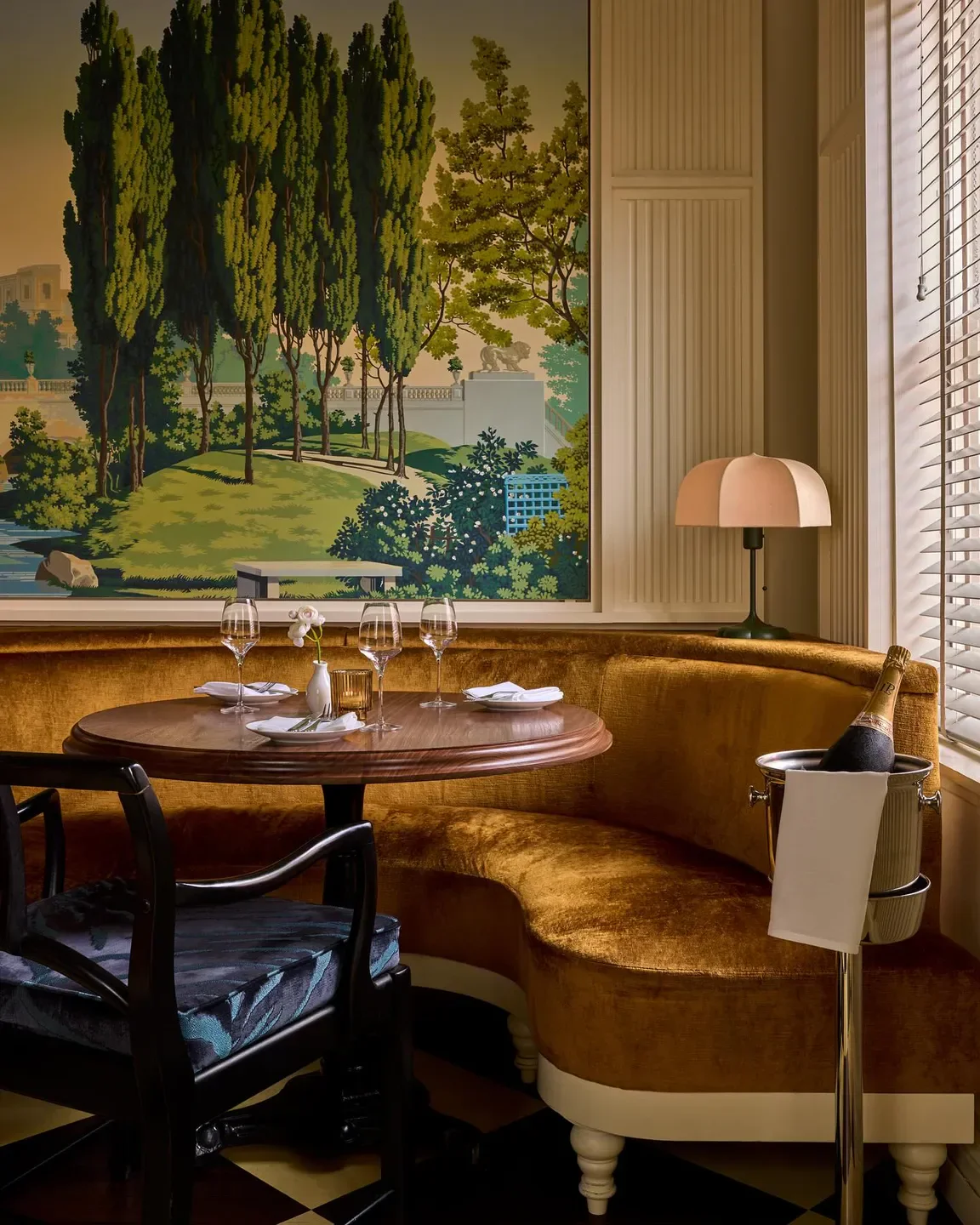 Cozy dining area at Friday Saturday Sunday in Philadelphia, featuring a scenic mural.