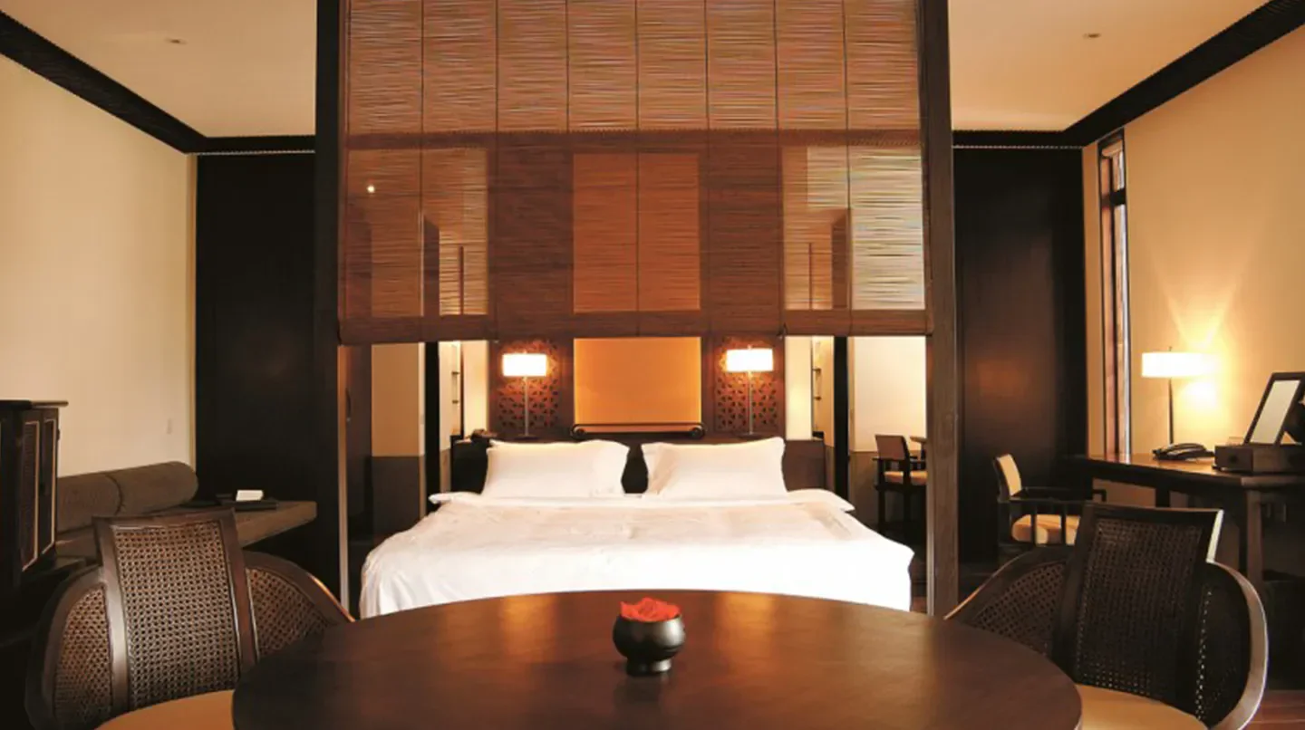 Cozy bedroom interior at Fuchun Resort Hotel Fuyang, Hangzhou, with elegant decor and design.