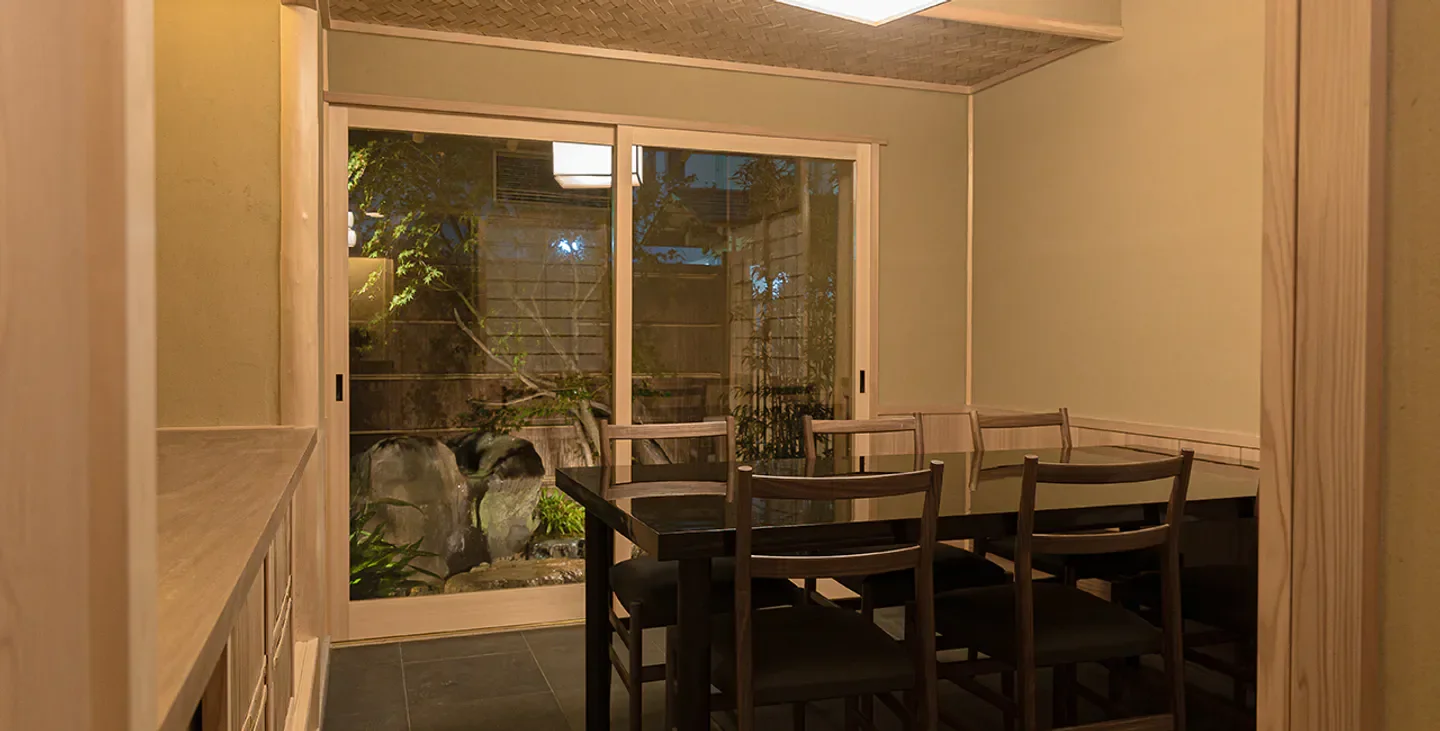 Interior dining space at Fushimimachi Kakoiyama restaurant in Osaka, showcasing a serene atmosphere.