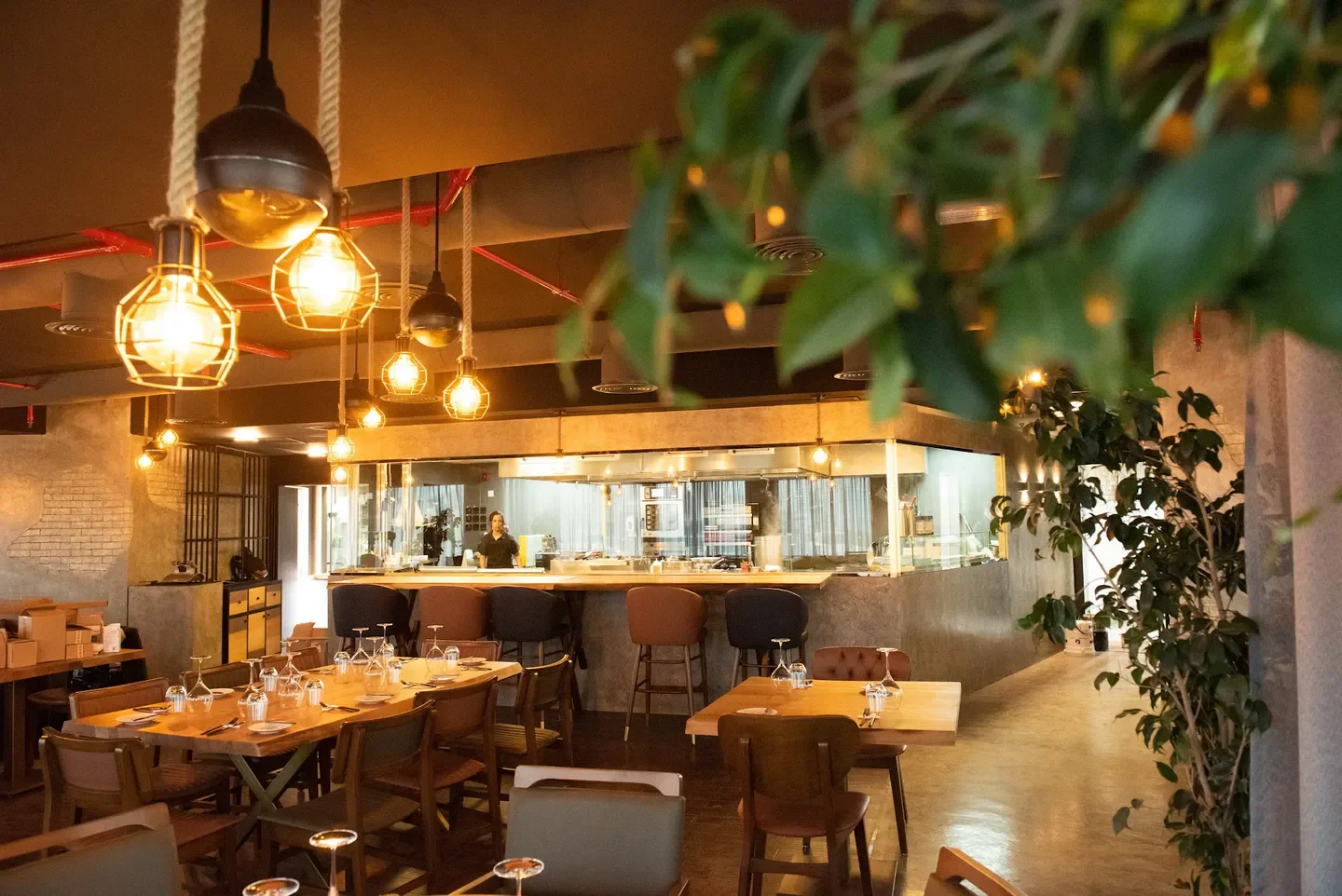 Interior of Fusions by Tala restaurant in Manama, featuring tables and kitchen area.