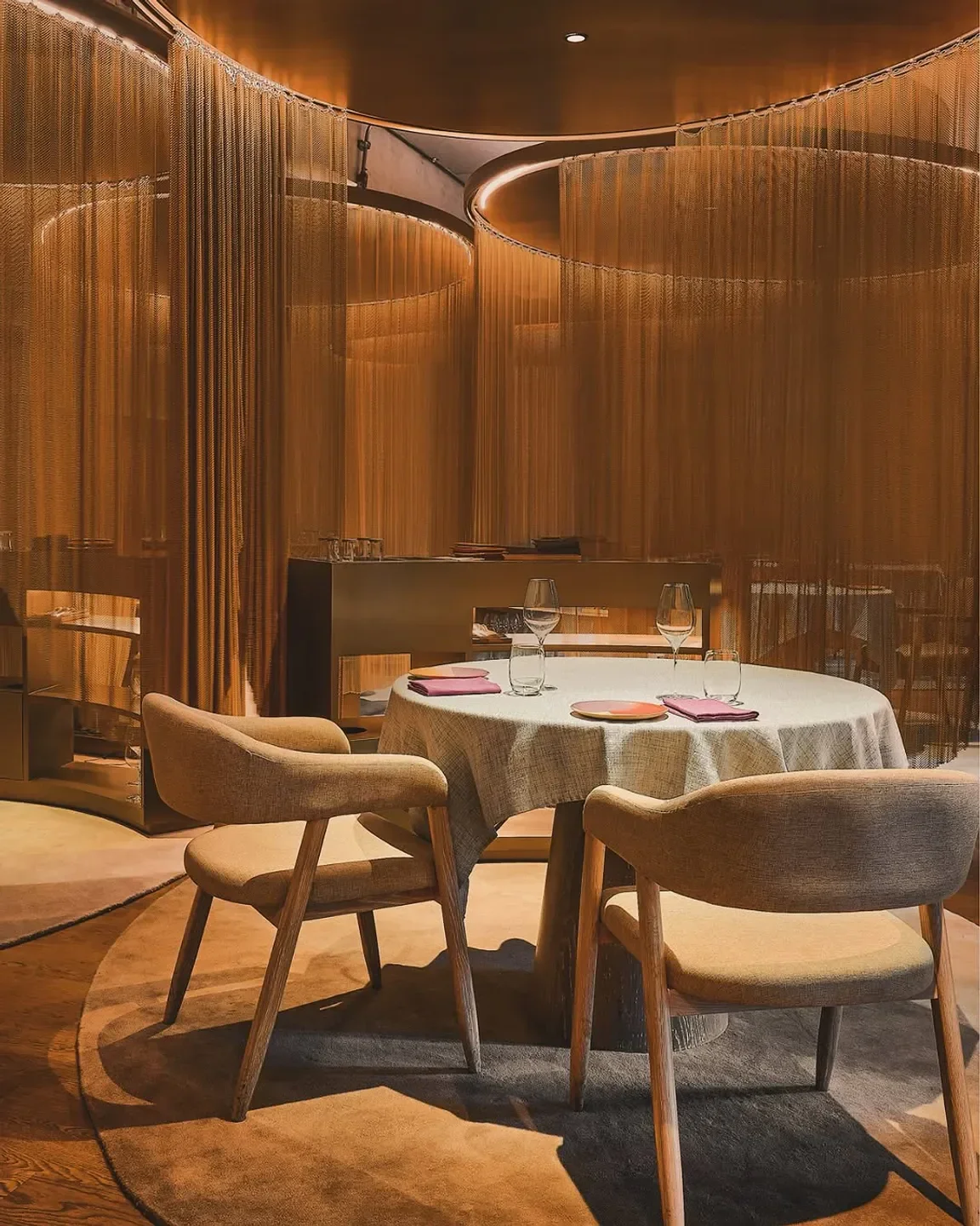 Cozy dining area at Gaa restaurant in Bangkok, featuring elegant table setting and decor