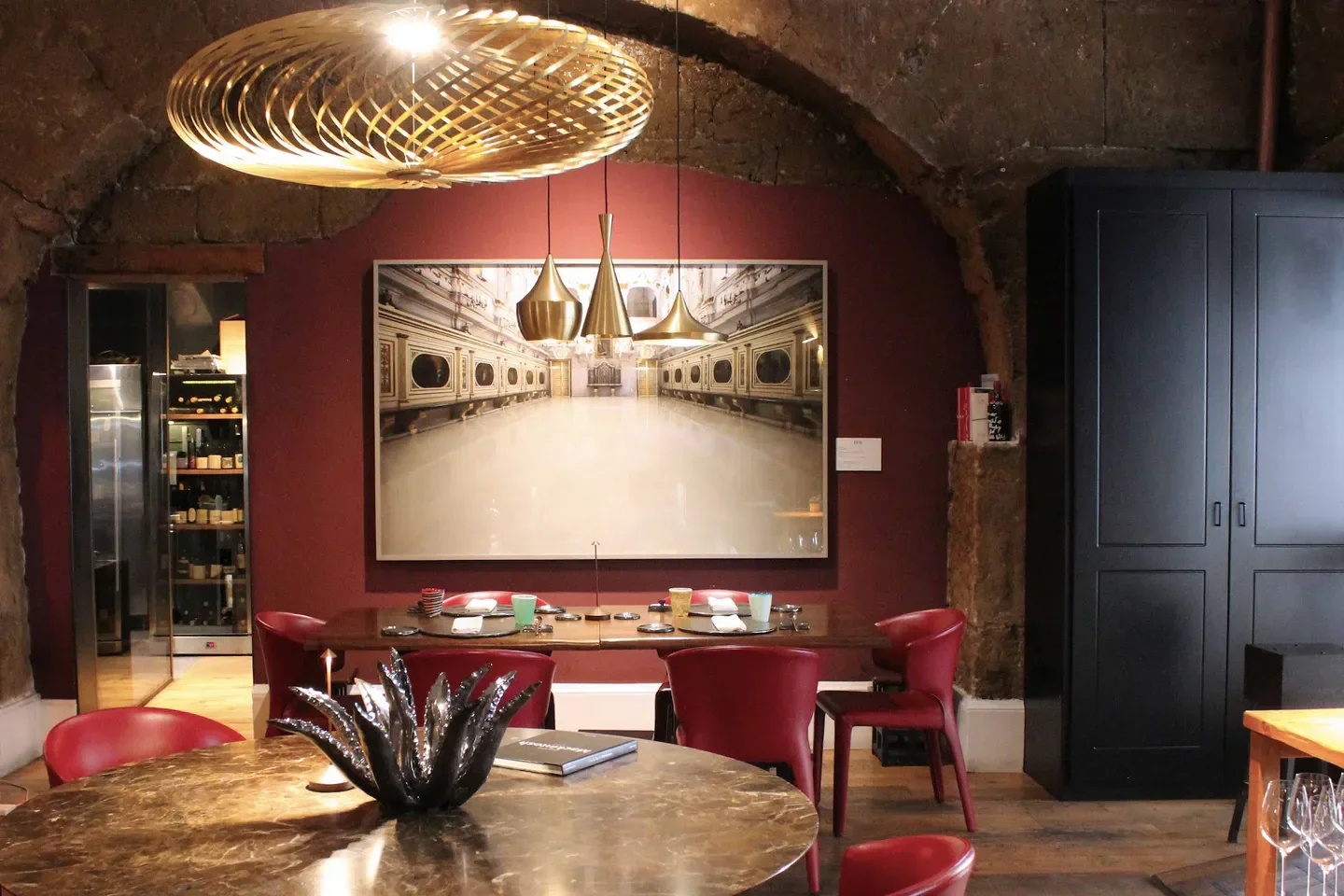 Stylish interior of Gagini Restaurant in Sicily, featuring unique lighting and artwork.