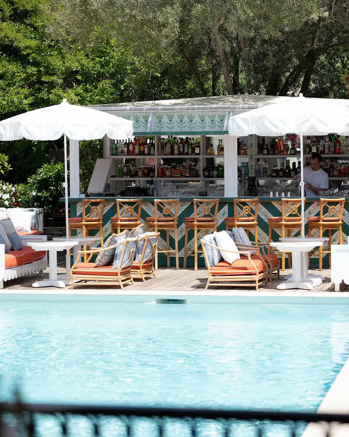 GAIA restaurant bar area by the pool with bamboo chairs and umbrellas in the city