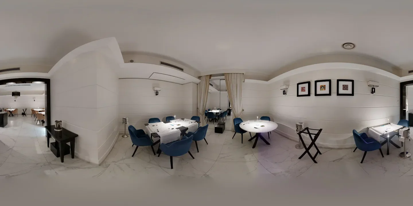 Elegant dining area at Gambero Rosso restaurant in Calabria, Italy with white walls