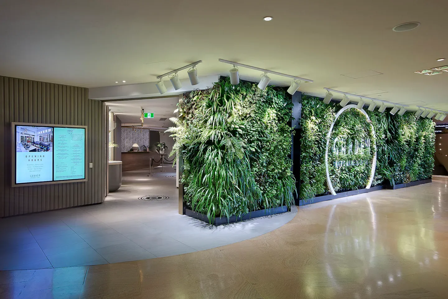 Entrance of Garden Kitchen & Bar in Gold Coast with striking green wall and neon sign.