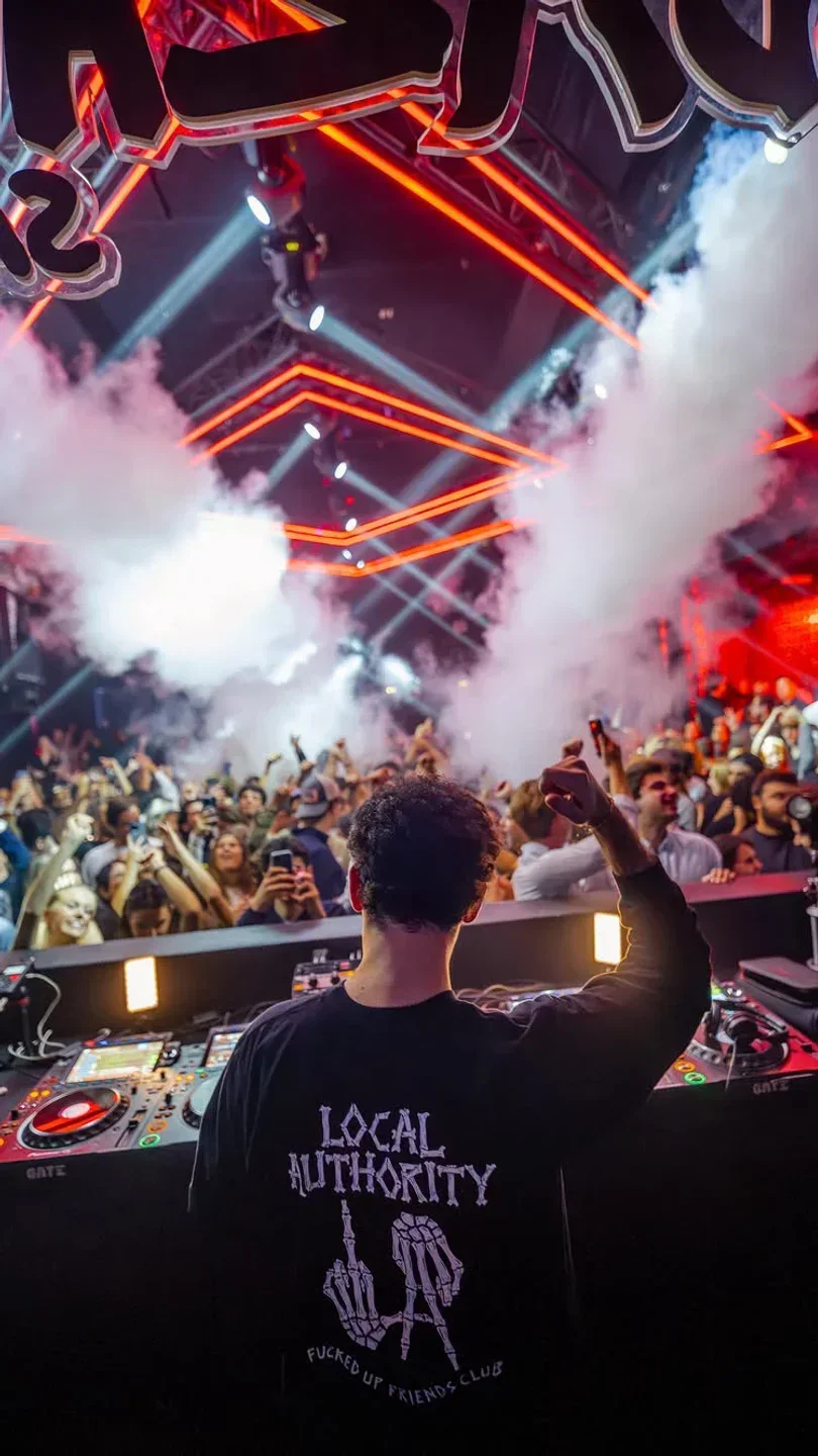 Energetic crowd at Gate Club in Paris, with DJ and vibrant lighting in the nightclub.