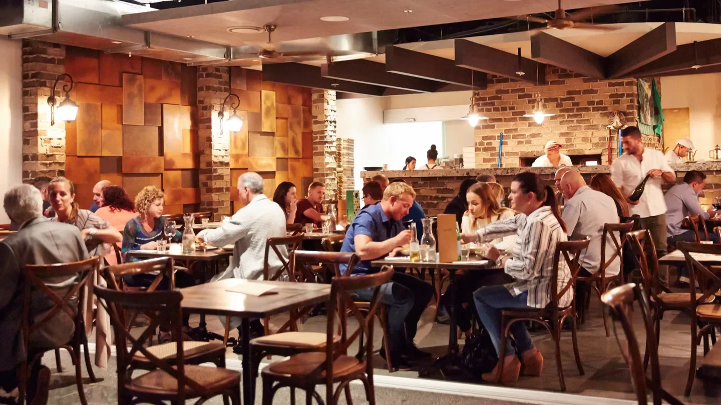 Dining scene at Gemelli Italian restaurant on the Gold Coast with patrons enjoying meals