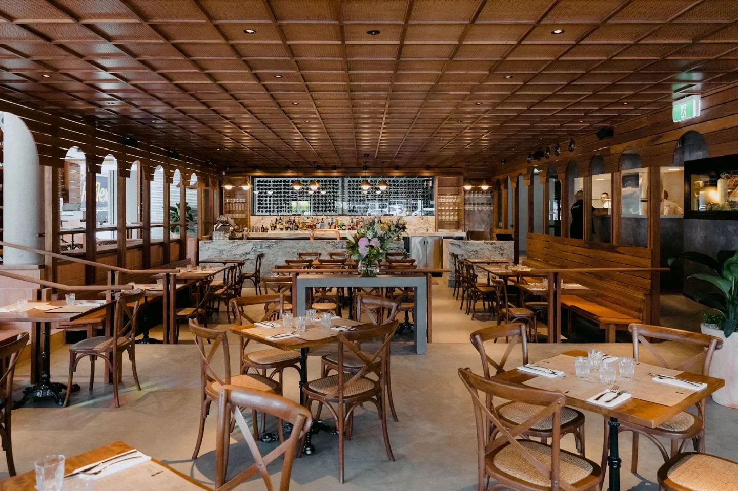 Interior of Gemelli Italian James St in Brisbane, showcasing stylish dining tables and bar