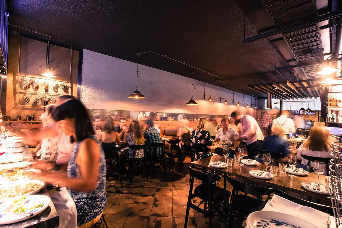 Busy interior of Gemellini Nobby Beach restaurant on the Gold Coast, with diners and staff