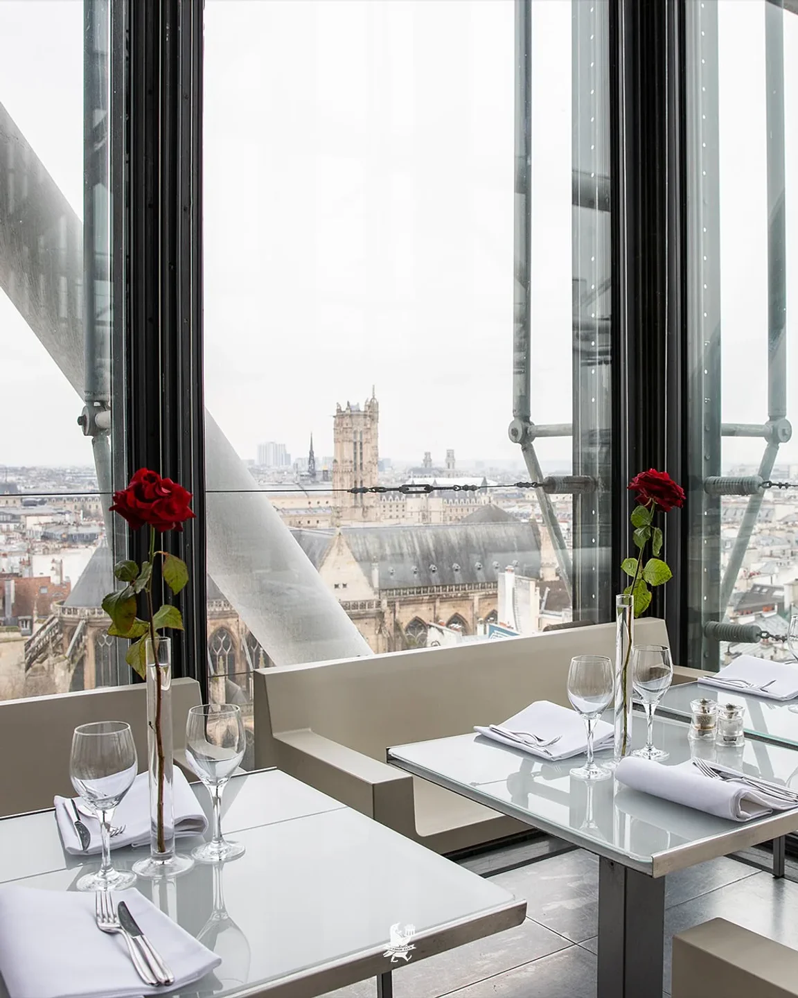 Georges Paris rooftop restaurant offers stunning city views with elegant table settings and red roses.