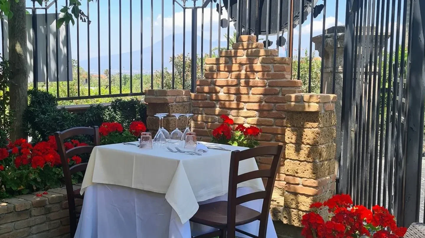 Outdoor dining at Gerani Ristorante in Campania, with a beautiful table setting.