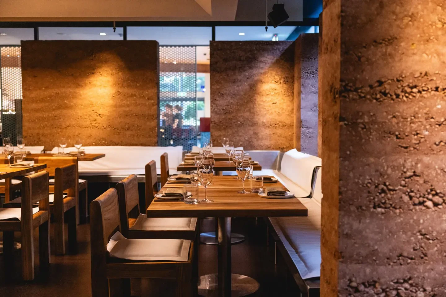 Interior dining at Gerard's Bistro in Brisbane, with stylish wooden tables and unique wall detail