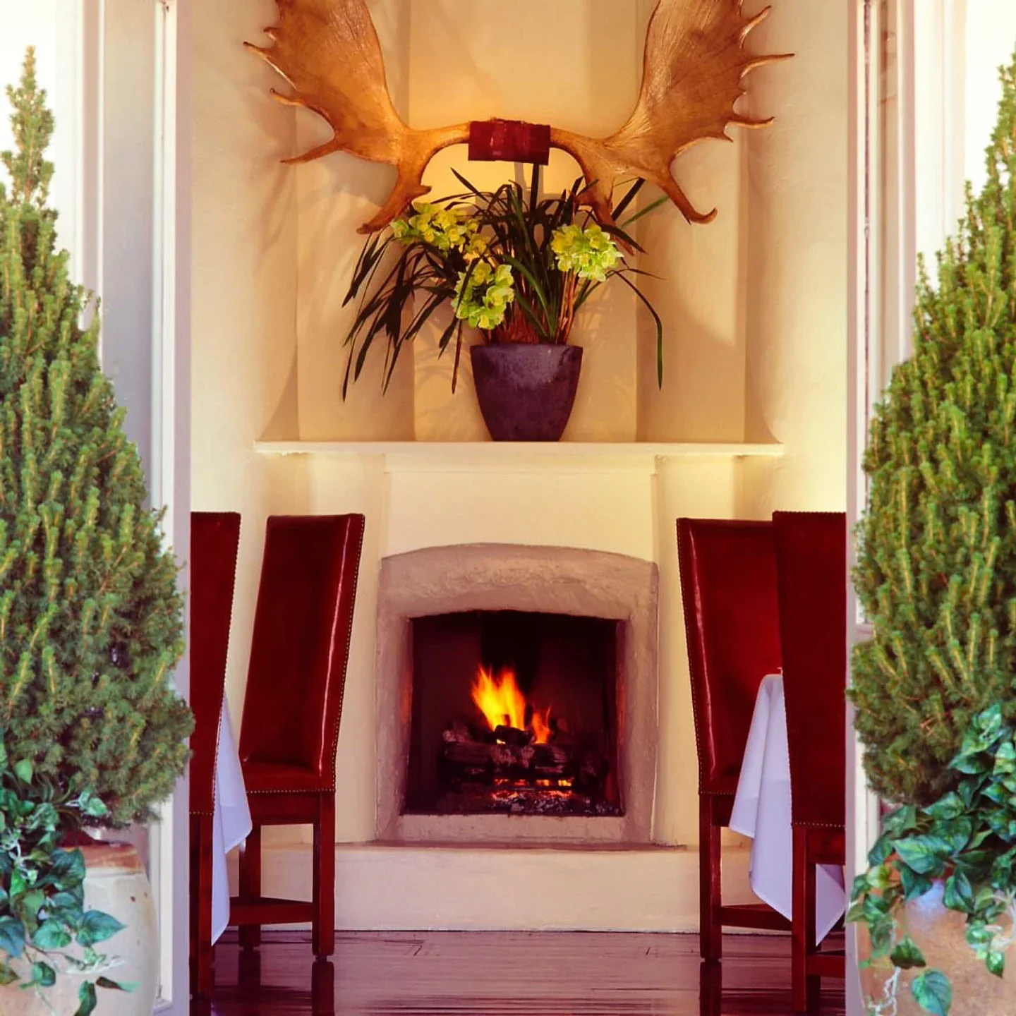 Cozy dining area with fireplace at Geronimo restaurant in Santa Fe, New Mexico, perfect for a special occasion.