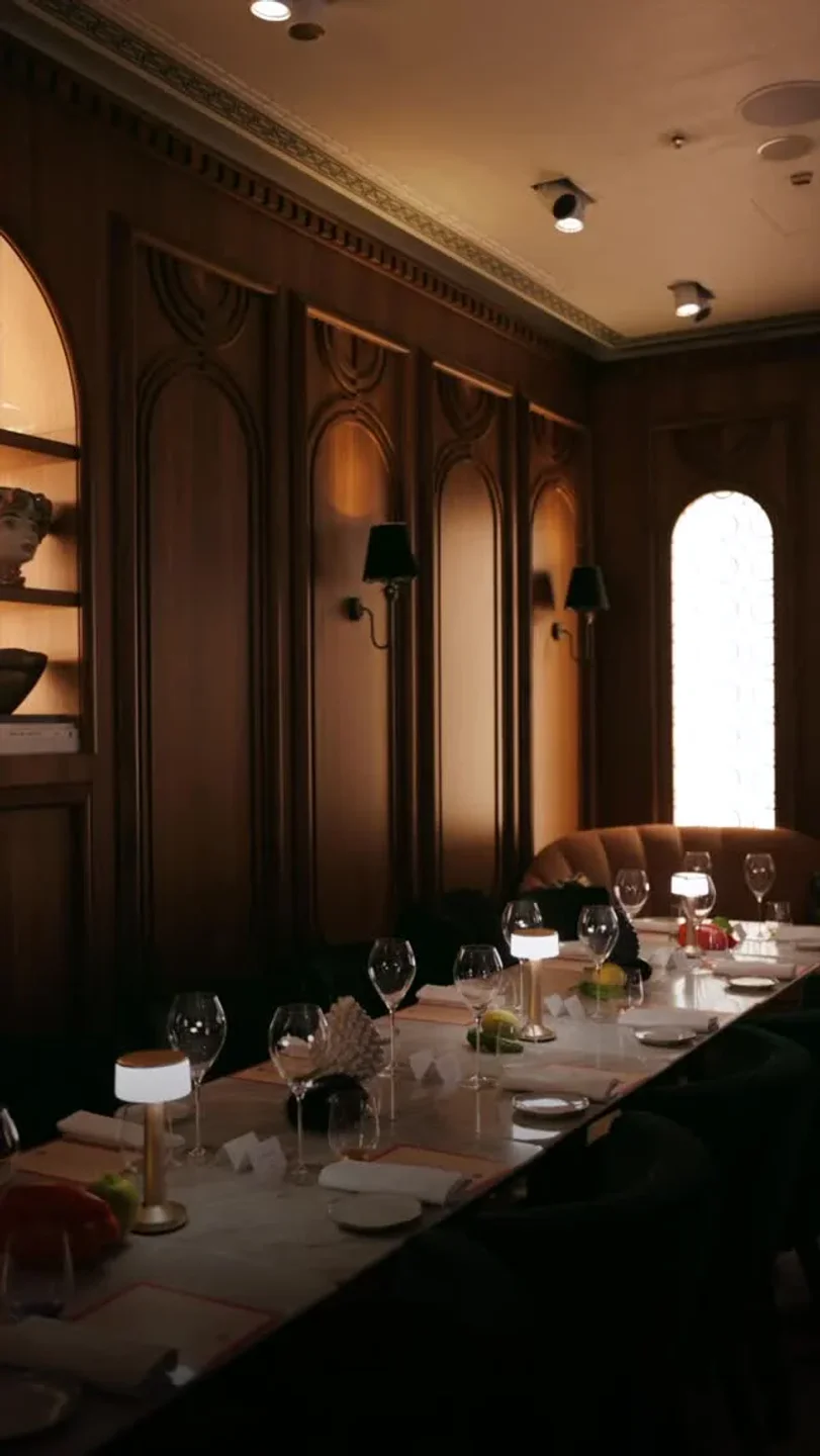 Giano restaurant in the city featuring an elegant dining room with a long table set for a meal.