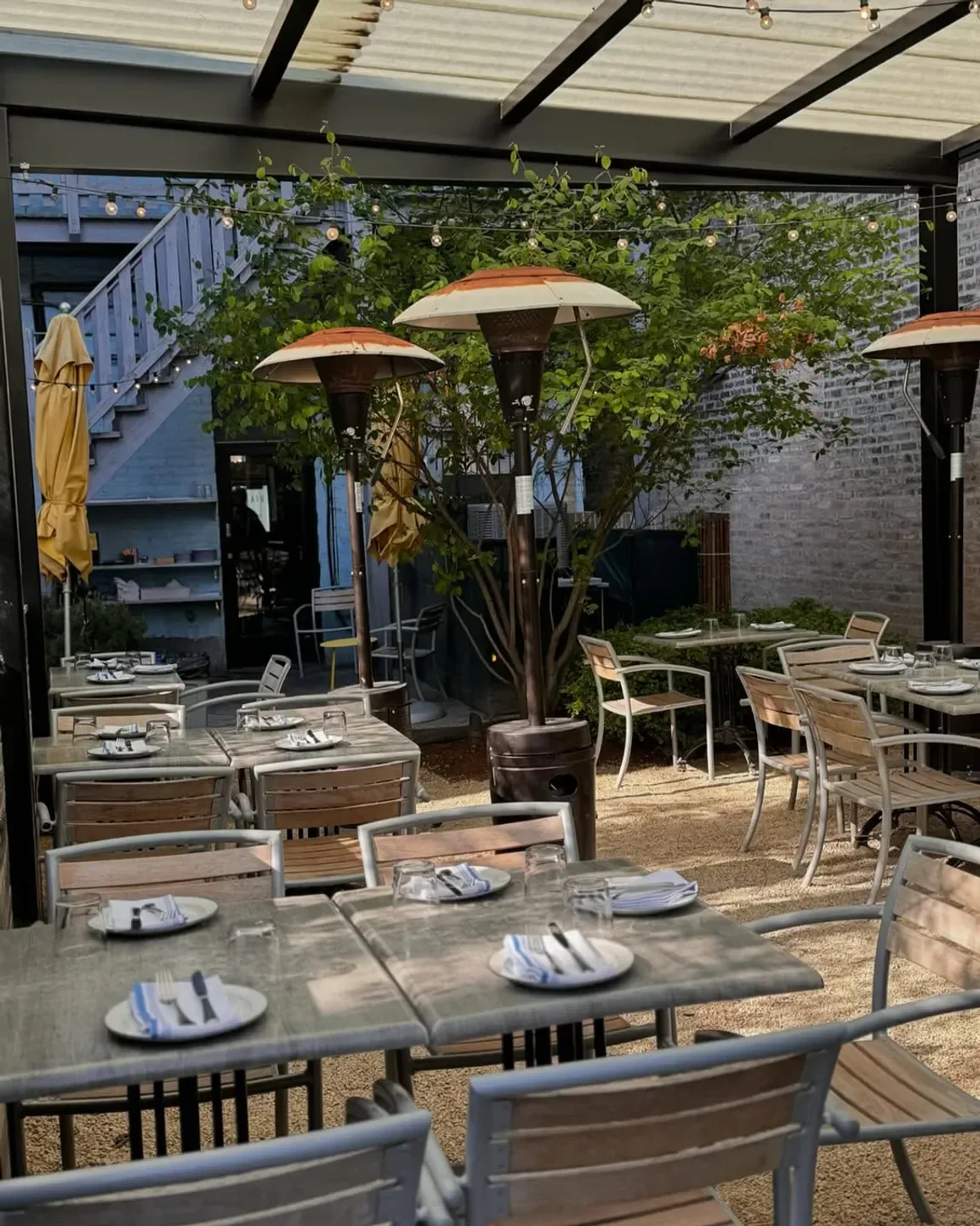 Outdoor dining area at Giant restaurant in Chicago with heaters and tables set