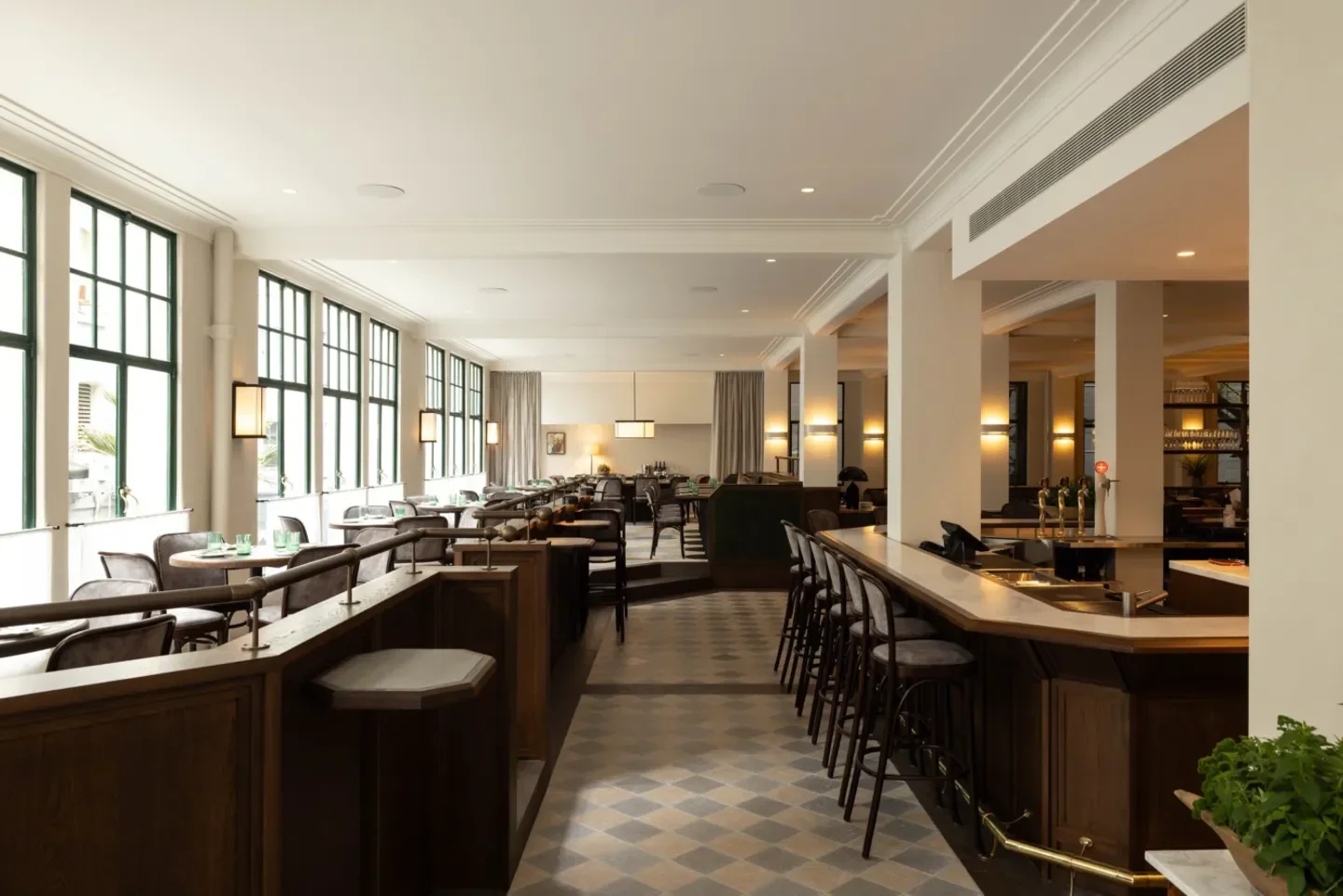 Interior of Gilt Brasserie in Auckland, showing bar and dining area with stylish design.