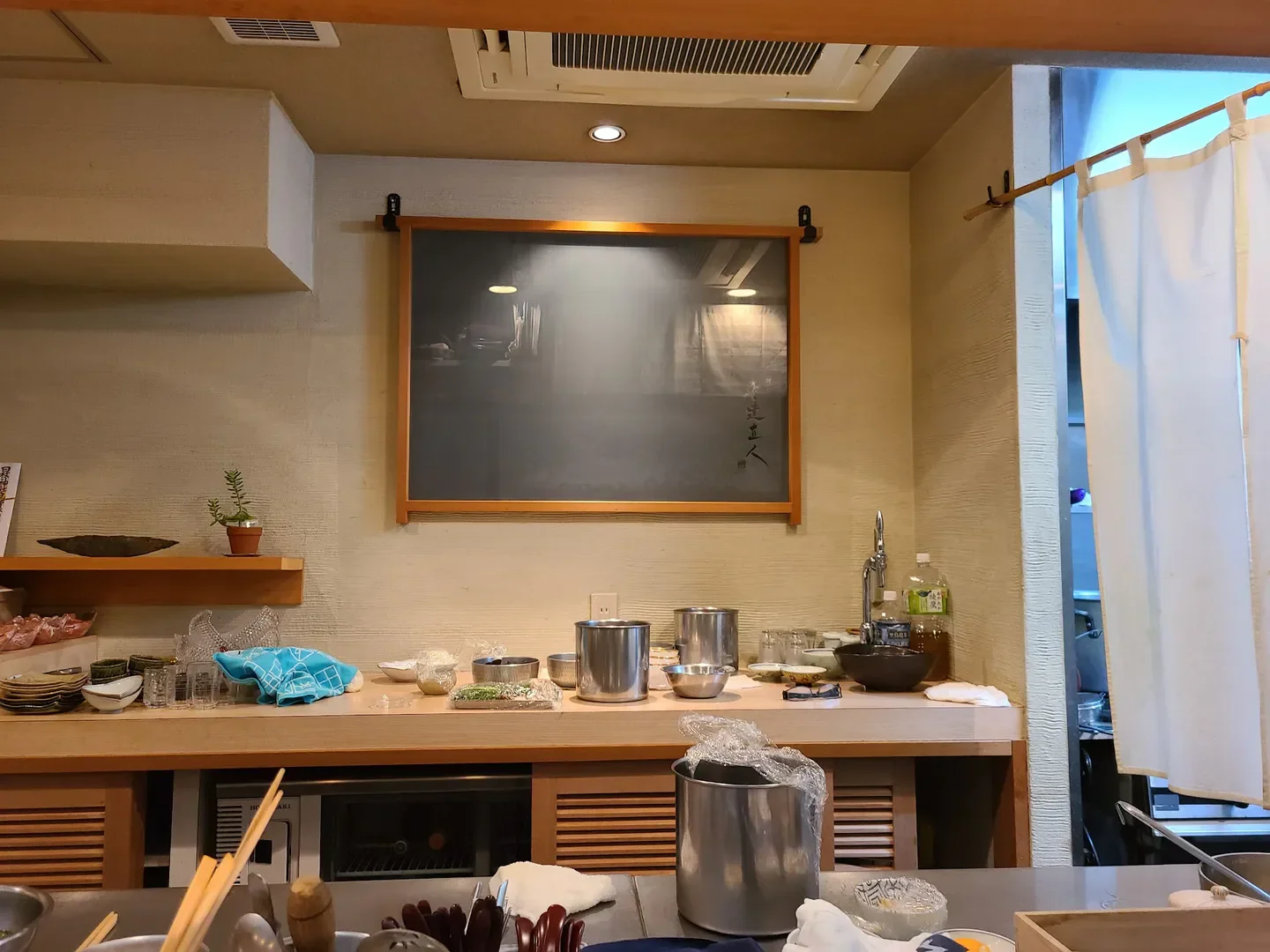 Interior of Ginza Adachi Naoto restaurant in Tokyo, showcasing the prep area and decor.